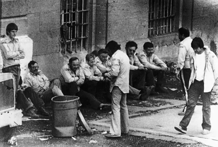 Framed Print : Prisoners Sitting Against Prison Wall Framed Print : Prisoners Sitting Against Prison Wall