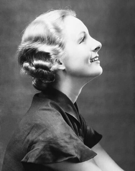 Profile of smiling woman, (B&W), close-up, portrait