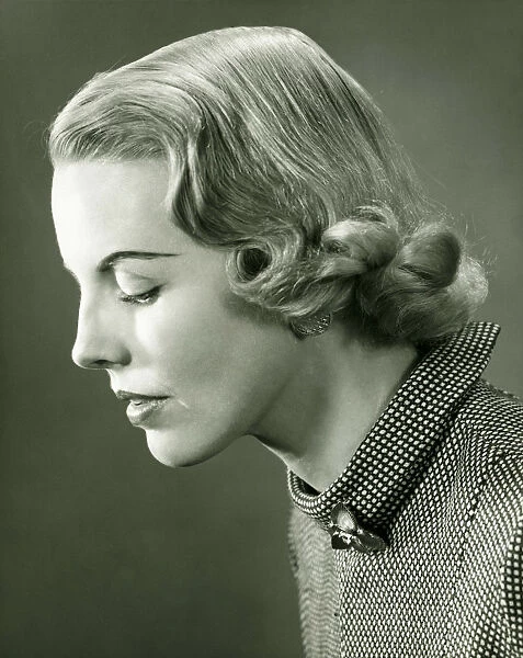 Profile of woman posing in studio, (B&W), portrait