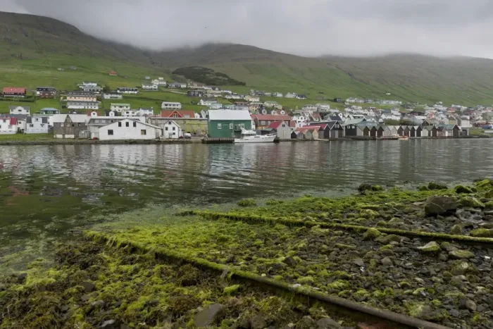 Framed Print : Rails on a boat ramp, covered in algae, boathouses at the back, Vagar, Faroe Islands, Denmark
