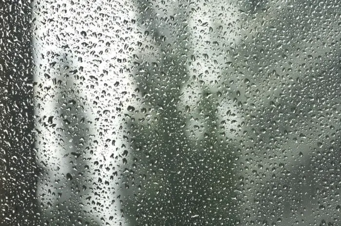 Framed Print : Rain drops on a window pane, blurry buildings in the back Framed Print : Rain drops on a window pane, blurry buildings in the back