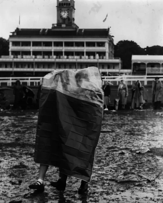 Framed Print : Rain Gear. Two spectators at Ascot wearing a tent-like bag to protect them from the rain Framed Print : Rain Gear. Two spectators at Ascot wearing a tent-like bag to protect them from the rain