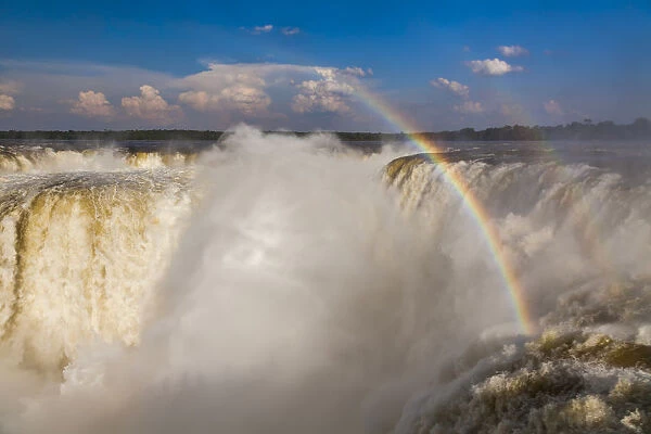 Rainbow over the Iguazu Falls at sunset