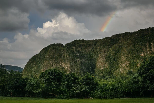 Rainbow over mogotes in ViAnales valley, in Cuba