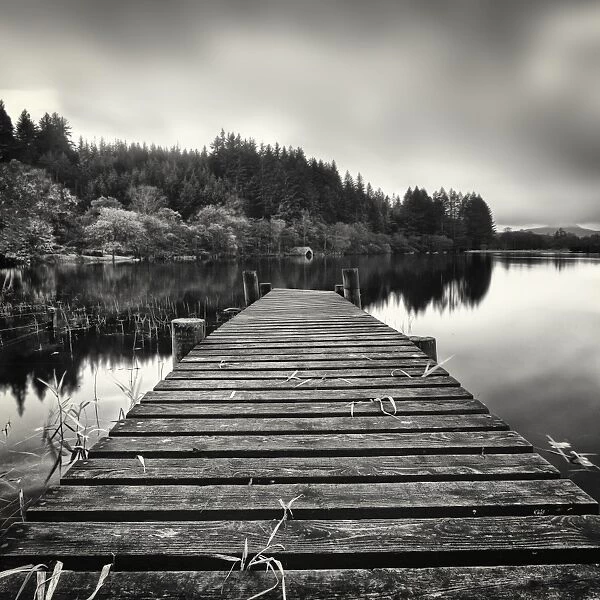 Out Reach. Wooden jetty leading out to boat house.Loch Ard Scotland