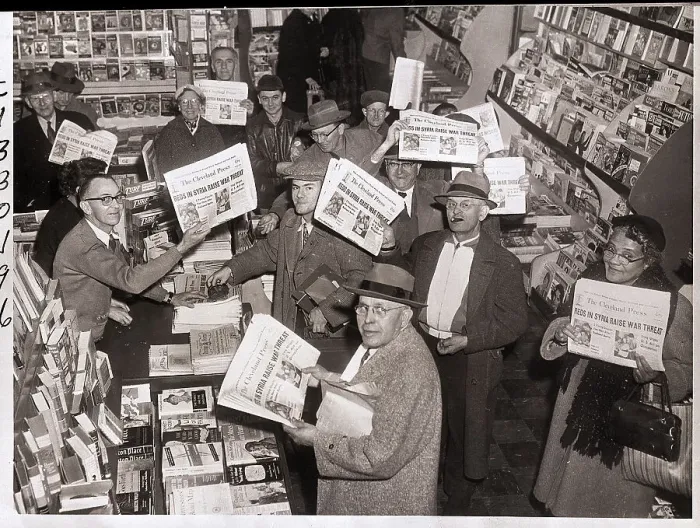 Framed Print : Readers Hold Up Newspapers in Bookstore Framed Print : Readers Hold Up Newspapers in Bookstore