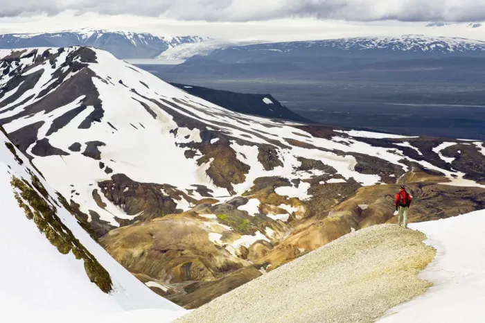Framed Print : Rear view of man hiking down a mountain Framed Print : Rear view of man hiking down a mountain