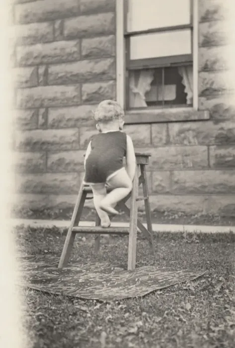 Framed Print : Rear View of a Toddler Climbing a Stepladder in a Garden Framed Print : Rear View of a Toddler Climbing a Stepladder in a Garden