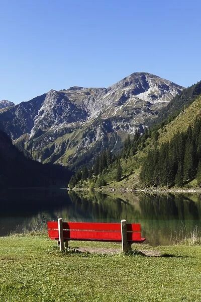 Red bench on Lake Vilsalpsee at Tannheim, Vilsalpseeberge mountains, Tannheimer Tal high valley, Tyrol, Austria, Europe