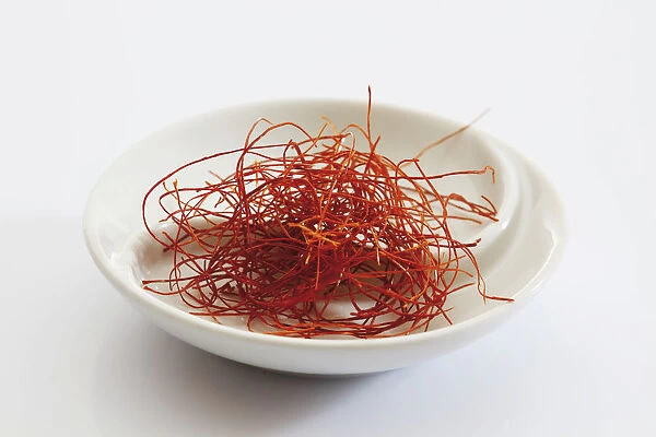 Red chilli threads in a small porcelain bowl