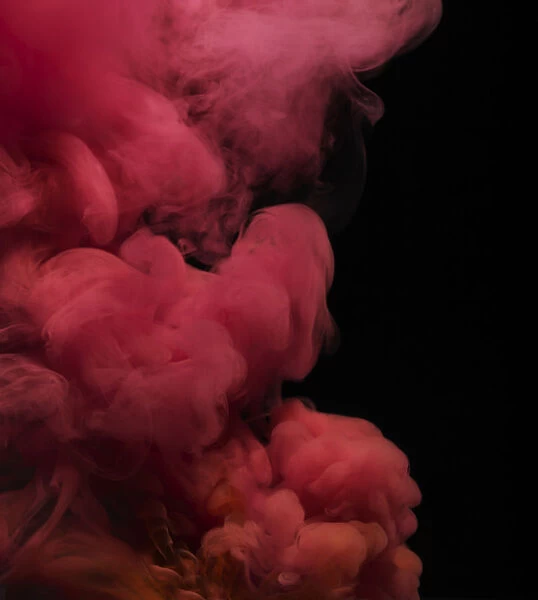Smoke. Red colored smoke that rises up and mixes in beautiful abstractions