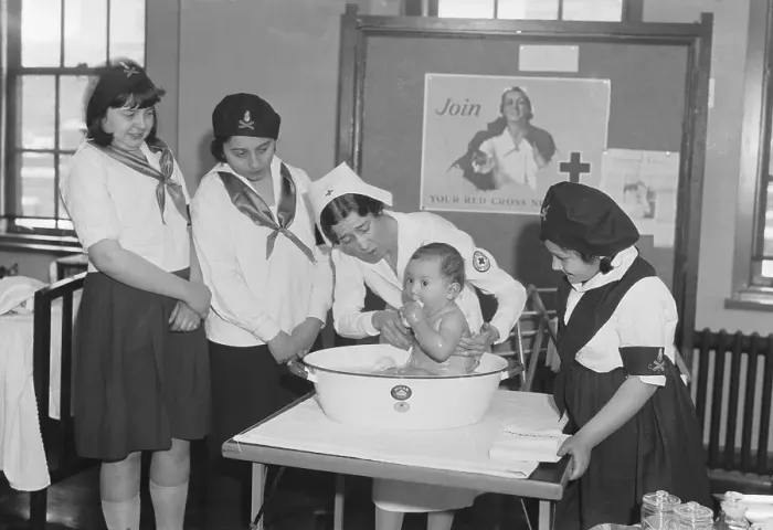 Framed Print : Red Cross Nurse Demonstrating Bathing of Baby to Camp Girls Framed Print : Red Cross Nurse Demonstrating Bathing of Baby to Camp Girls