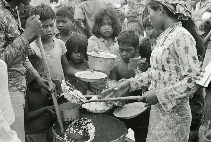 Framed Print : Red Cross Worker Feeding Children Framed Print : Red Cross Worker Feeding Children