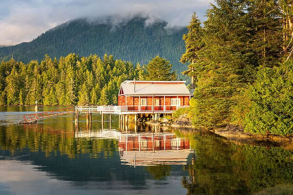 Red dock house with pier over the harbour water in Tofino, Vancouver Island, Canada