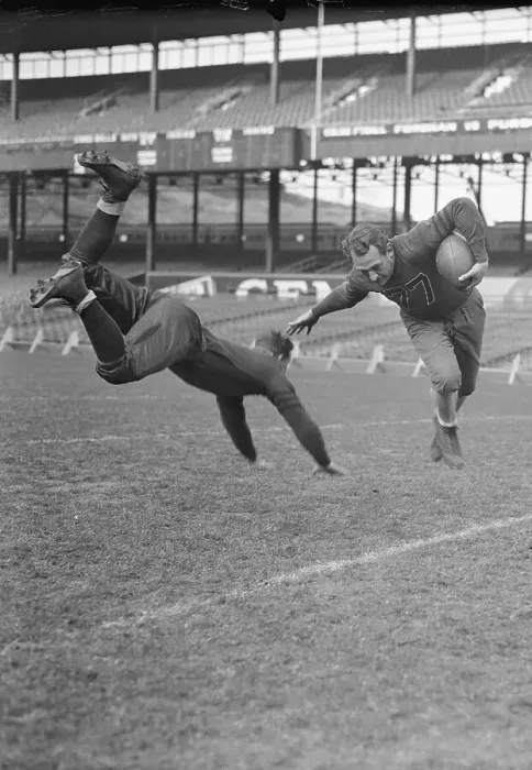 Framed Print : Red Grange Dodging Tackle
