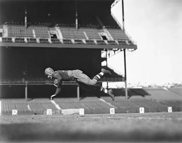 Framed Print : Red Grange Jumping in Air
