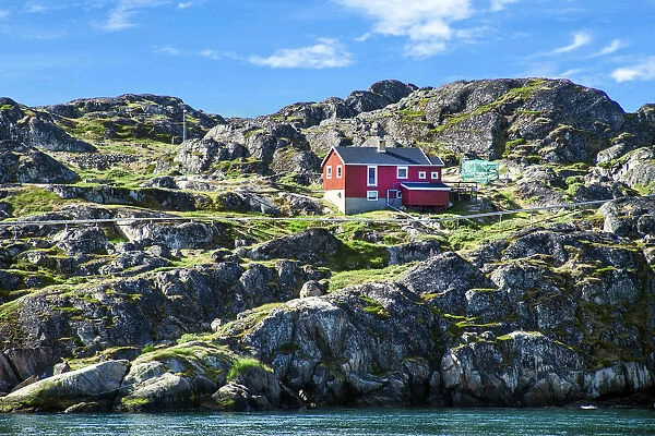 Red house on rocky coastline, Sisimiut, Greenland