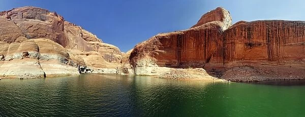 Red Navajo sandstone cliffs, rock formations rising from Lake Powell, Page, Arizona, USA