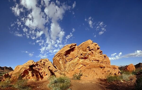 Red sandstone formation with blue cloudy sky in morning light, on the North Shore Road, Valley of Fire, Nevada, United States