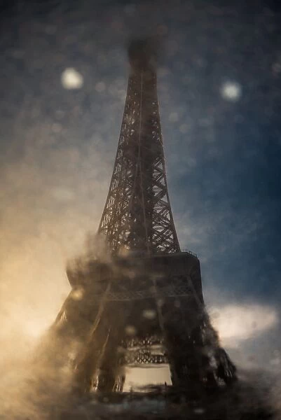 Reflection of Eiffel tower on the wet road