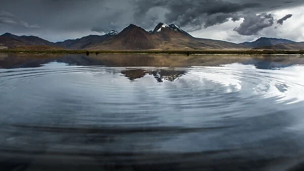 reflection of mountains with ripple foreground