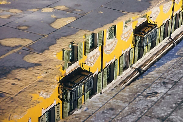 Reflection of a yellow building in a puddle, Nice, France