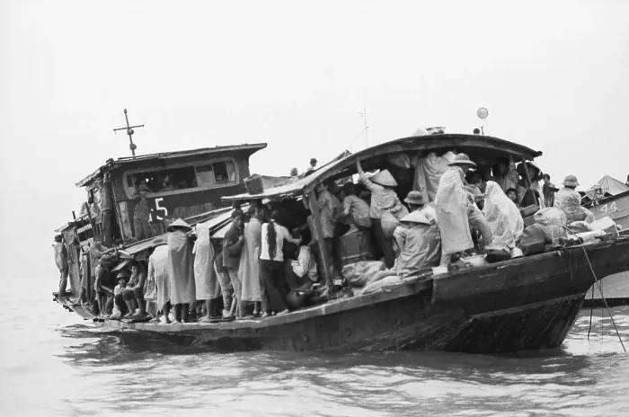 Framed Print : Refugees Huddled On Boat In Rain Downpou Framed Print : Refugees Huddled On Boat In Rain Downpou