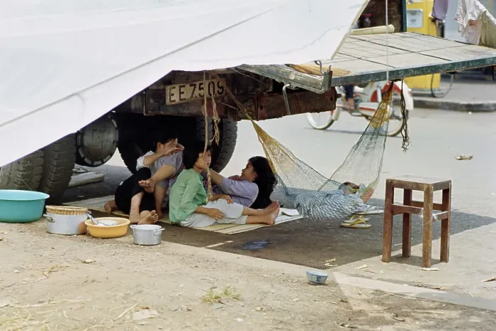 Framed Print : Refugees Sheltering Under Truck Framed Print : Refugees Sheltering Under Truck