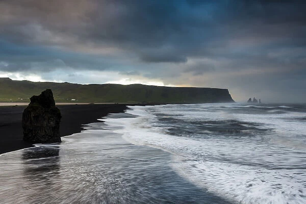 Reynisdrangar rock formation, dramatic clouds, black sand beach, near Vik i Myrdal, South Coast, Suourland, Iceland