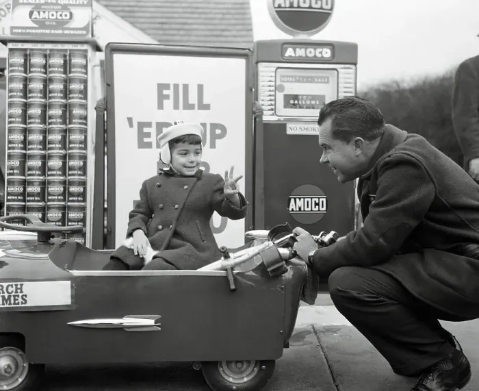 Framed Print : Richard Nixon Servicing a Young Girl's Car Framed Print : Richard Nixon Servicing a Young Girl's Car