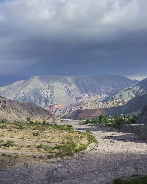 Riverbed of the Purmamarca and Cerro de los Siete Colores or Hill of Seven Colors in Purmamarca, Jujuy Province, Argentina