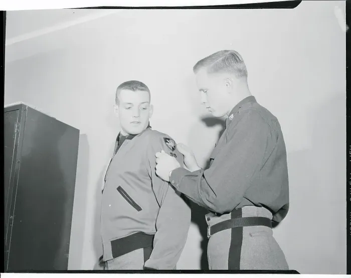 Framed Print : Robert Ferris Helping Pete Vann with Shoulder Patch