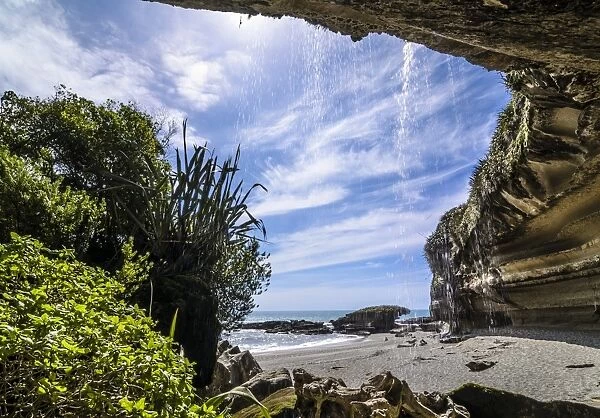 Rock formations of Trumans Cove at the beach with a waterfall, Te Miko, Trumans Bay, Paparoa National Park, Punakaiki, South Island, New Zealand, Oceania