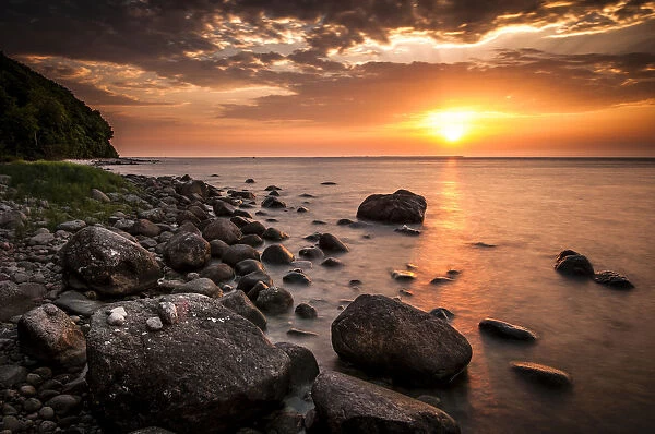Rocks on a beach at sunset by the sea, bei Nardewitz, Rugen island, Rugen, Mecklenburg-Western Pomerania, Germany