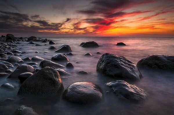 Rocks on a beach at sunset by the sea, bei Nardewitz, Rugen island, Rugen, Mecklenburg-Western Pomerania, Germany