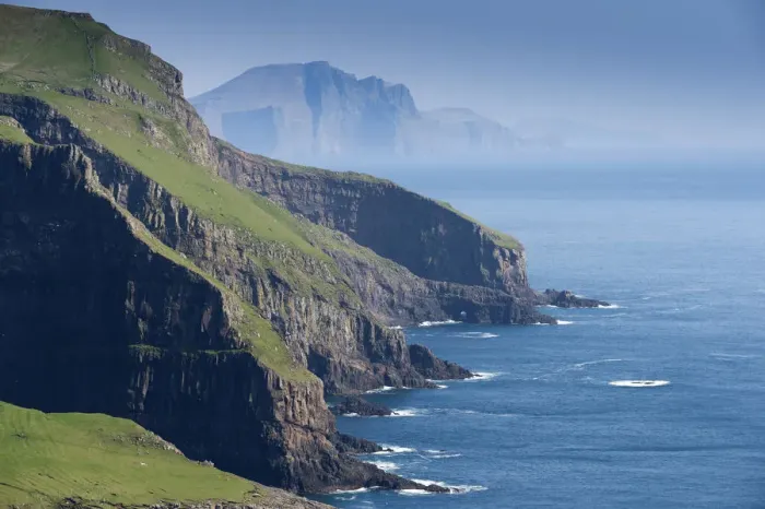 Framed Print : Rocky coast of Mykines, Vagar behind, Mykines, Utoyggjar, Faroe Islands, Denmark
