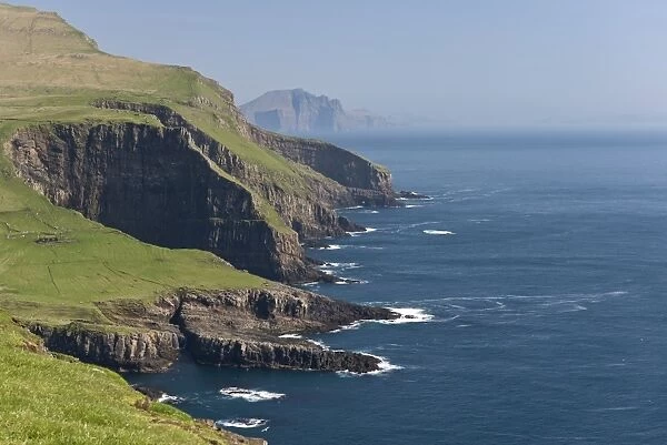 Rocky coast of Mykines, Vagar behind, Mykines, Utoyggjar, Faroe Islands, Denmark