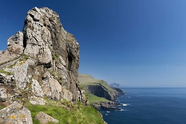 Rocky coast of Mykines, Vagar behind, Mykines, Utoyggjar, Faroe Islands, Denmark