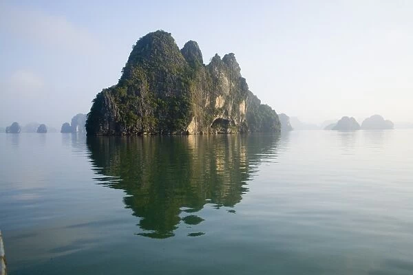 Rocky islands with still water in misty morning