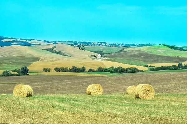 Rolling landscape with haystacks in Val d Orcia