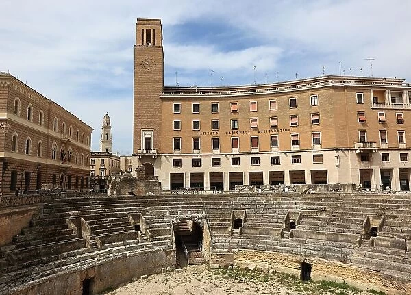 Roman amphitheatre, on the right the cube-shaped Palazzo del Seggio, Lecce, Apulia, Italy