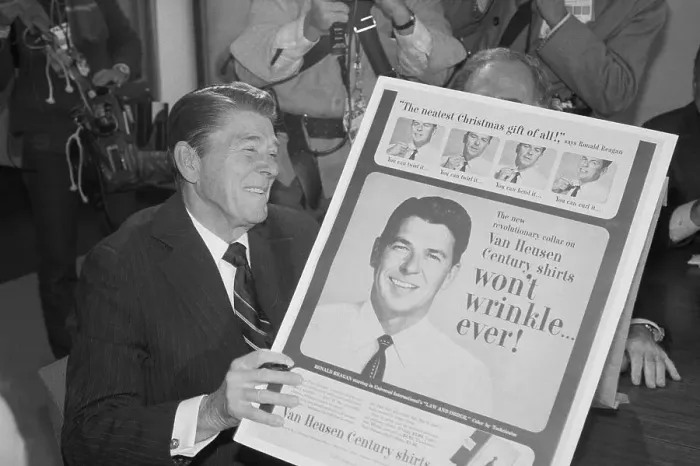 Framed Print : Ronald Reagan Holding an Advertisement Framed Print : Ronald Reagan Holding an Advertisement