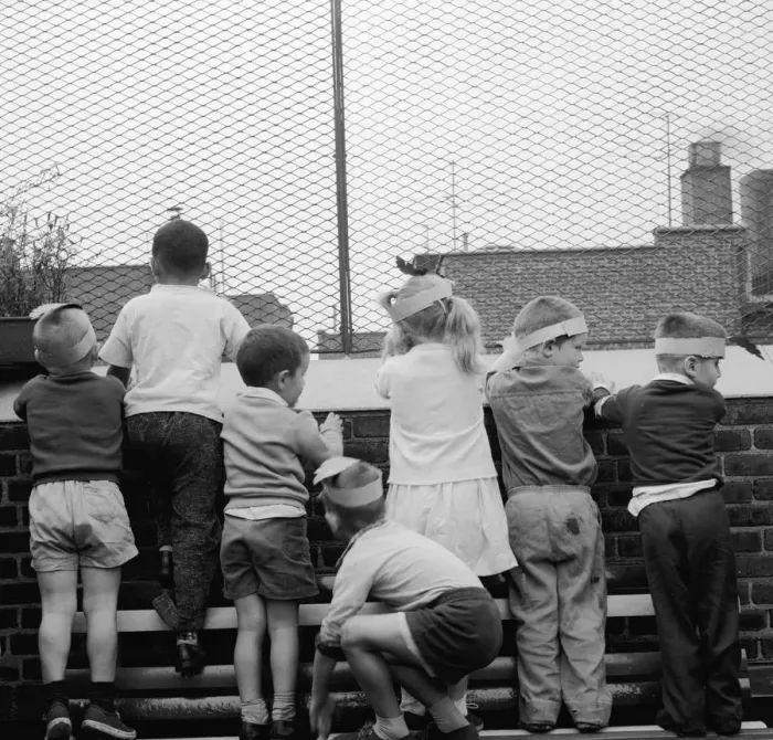 Framed Print : Roof View. Children looking out from the rooftop playground of the Jones Framed Print : Roof View. Children looking out from the rooftop playground of the Jones