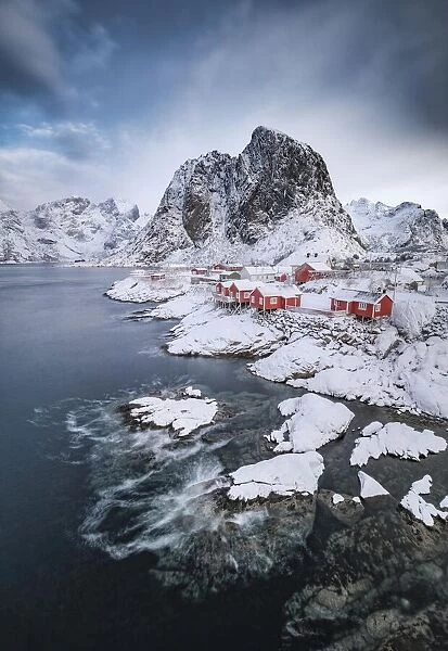 Rorbuer fishermens cabins on the snowy fjord, village view of the fishing village Hamnoy