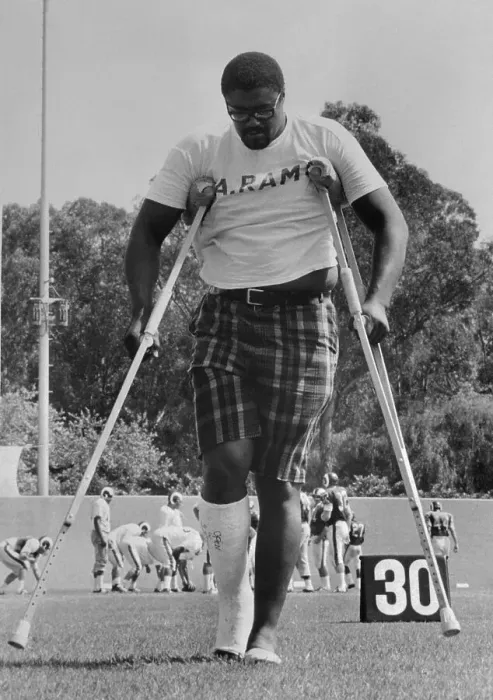 Framed Print : Rosey Grier Walking on Crutches Framed Print : Rosey Grier Walking on Crutches