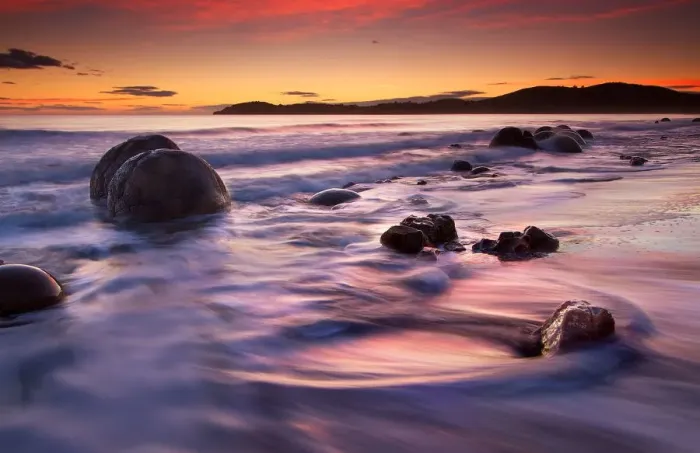 Framed Print : Round boulders on beach at sunrise Framed Print : Round boulders on beach at sunrise