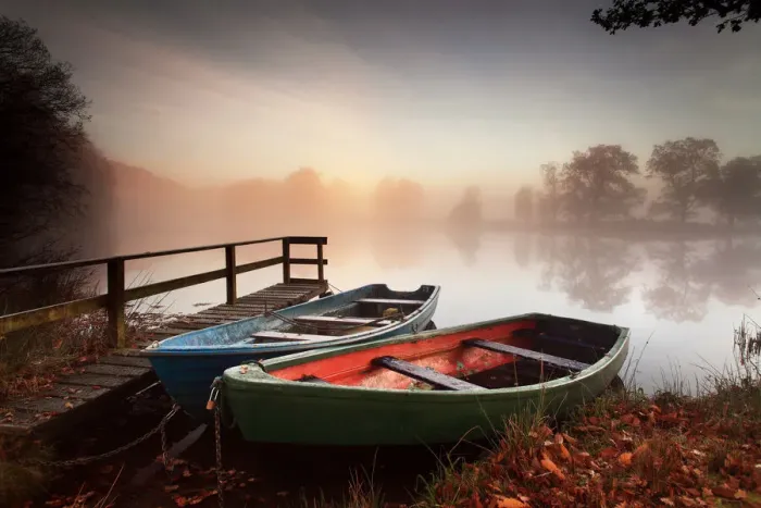 Framed Print : Rowing boats moored on banks of wooded lake Framed Print : Rowing boats moored on banks of wooded lake