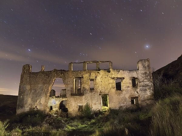 Ruins of a farmhouse at night