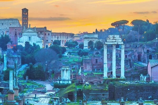 The ruins of Temple of Castor and Pollux and Arch of Titus at dawn in the Roman Forum, Rome, Italy