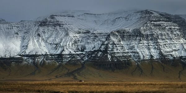 a rural road and mountain in Iceland